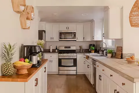 Bright and modern, this fully stocked kitchen features stainless steel appliances, spacious counters, and everything needed for easy meals.