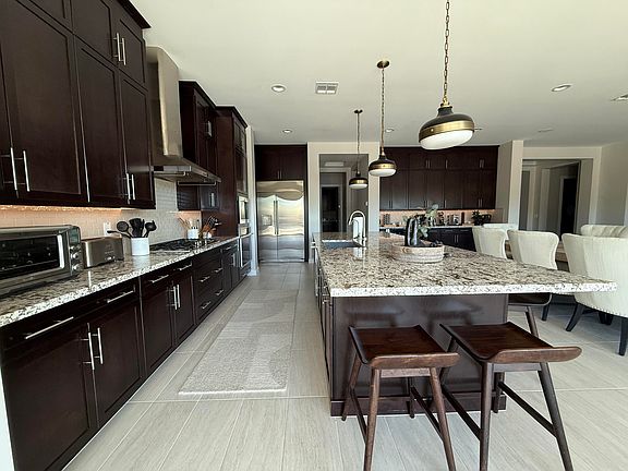 Oversized gourmet kitchen fully equipped with upgraded appliances.