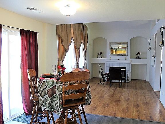 Family Room seen from Kitchen.  Sliding Door on left accesses back yard.  Laundry Room and Garage is accessed on the right.