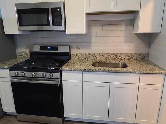 New kitchen cabinets with granite counter and stainless steel appliances