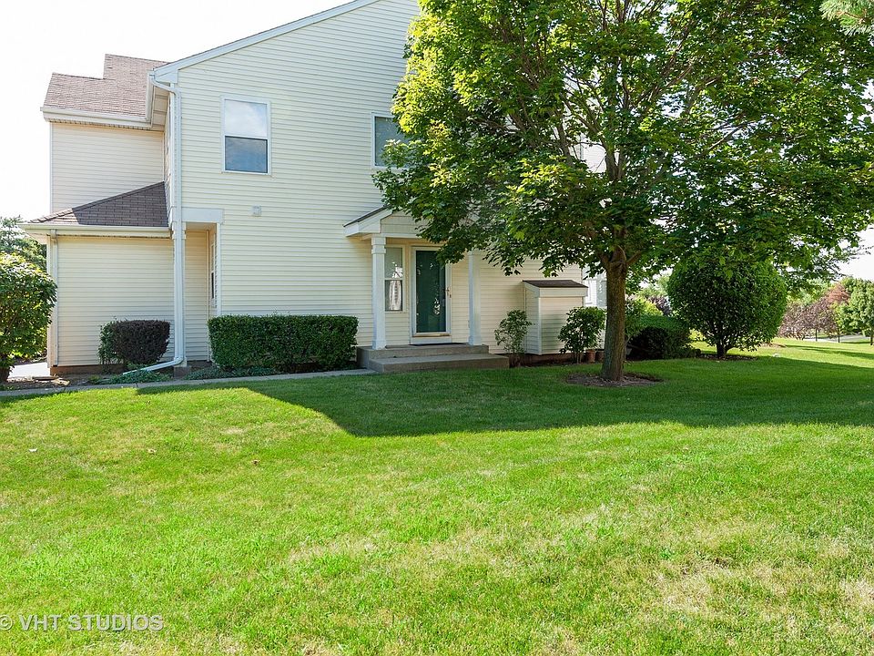 Side view, this townhouse has a very long driveway and a 2 car attached garage