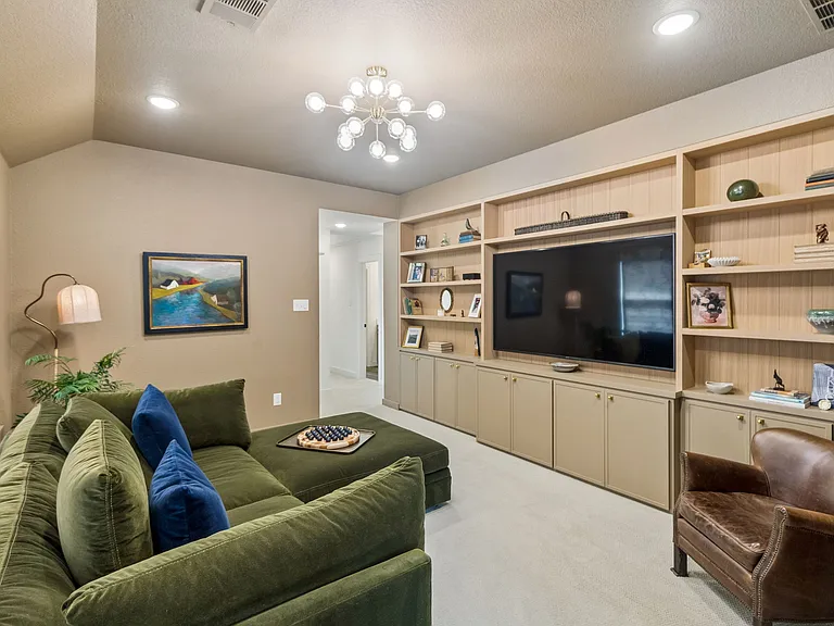 Library off primary bedroom with smart TV.