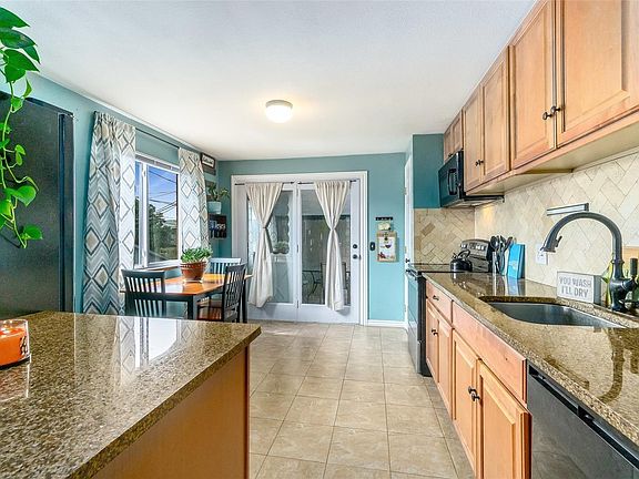 Kitchen with granite counter tops and tile floors