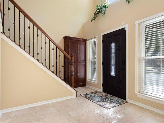 This front entryway leads you upstairs to your secondary bedrooms and has built in shelving for extra storage.