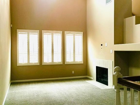 High ceiling family room with fire place and computer nook.