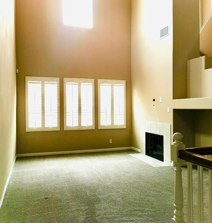 High ceiling family room with fire place and computer nook.