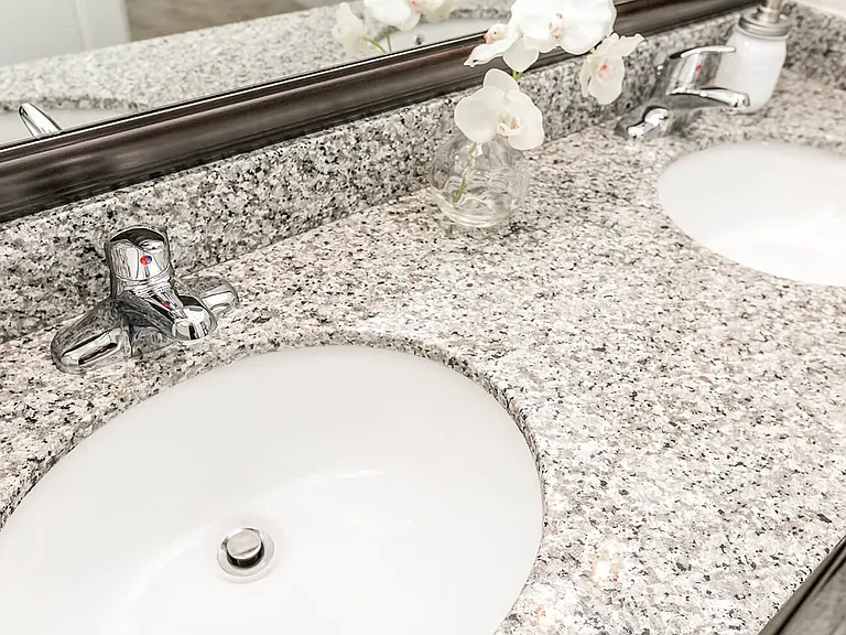 Solid, granite countertops in kitchen and baths