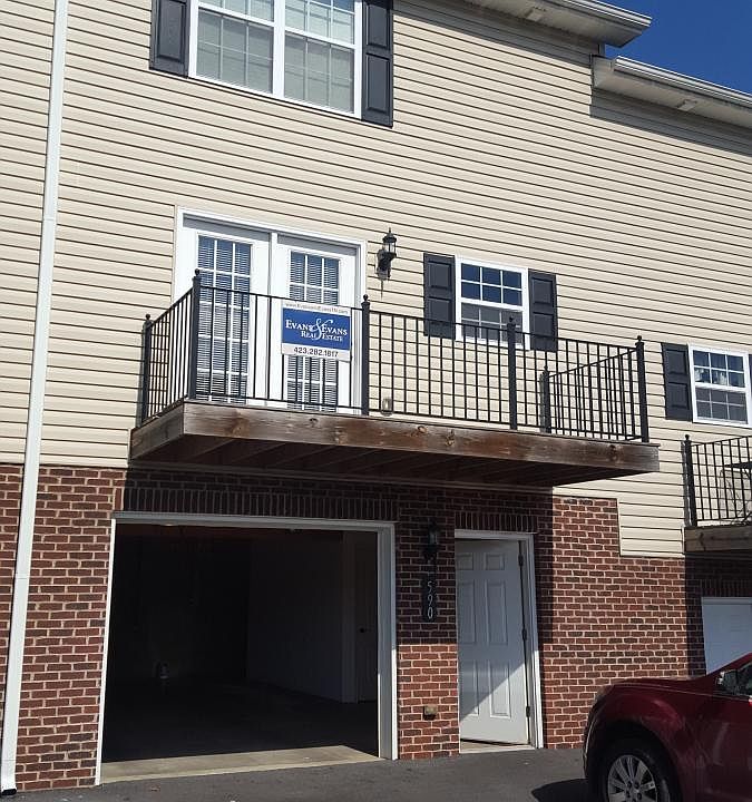 Balcony off kitchen/dining area. Garage entrance on lower floor.