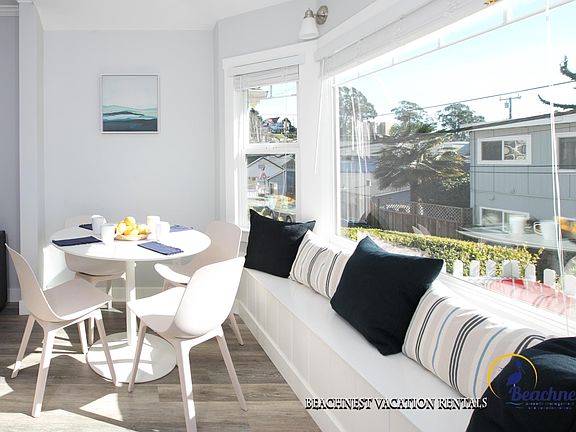 Entrance opens to breakfast nook with window bench seating.