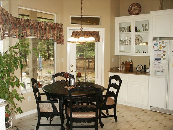 Enjoy your meals sitting in this pretty eating area off the kitchen. The door 