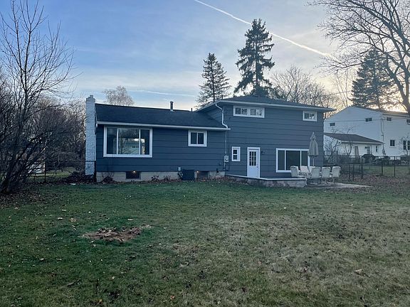 Spacious backyard with newly paved patio for entertainment.