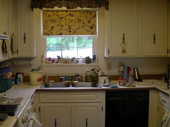 Light and bright kitchen has gas range and eating nook.