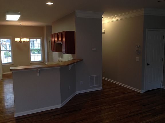 from back wall of living room looking to kitchen and hall