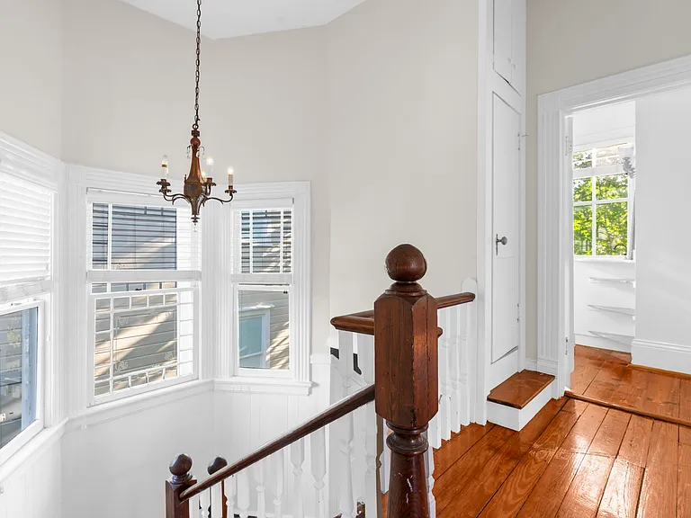 Top of Staircase on Second Floor with a View into the Full Bath for Two Bedrooms