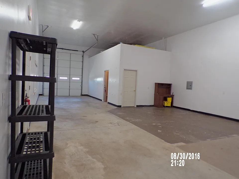 Warehouse showing the overhead door. Closed door is a small store room. Great light in here!