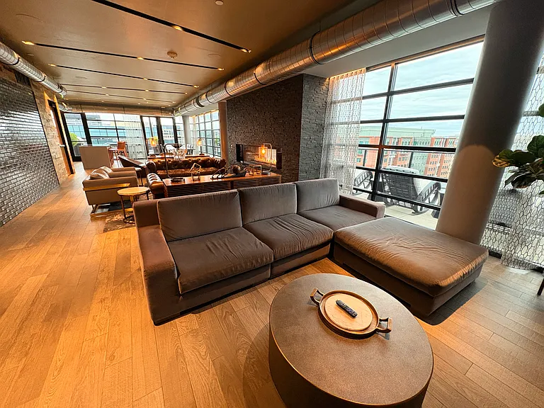 Additional view of the clubhouse lounge. TV for watch parties on the opposite wall of the couch.