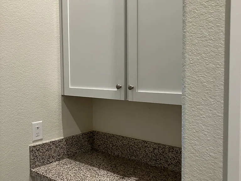 Extra cabinet in the hallway to the laundry room.