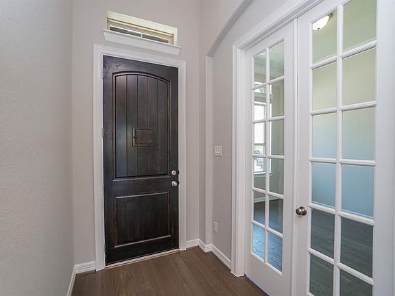 Beautiful entrance with 9-ft wooden door with transom window over, and study to the left