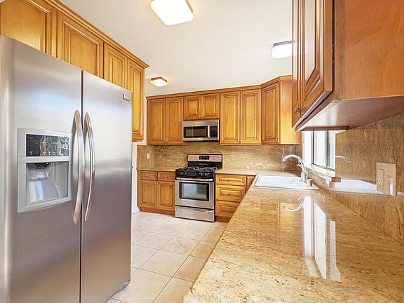 Kitchen with gas stove and microwave.