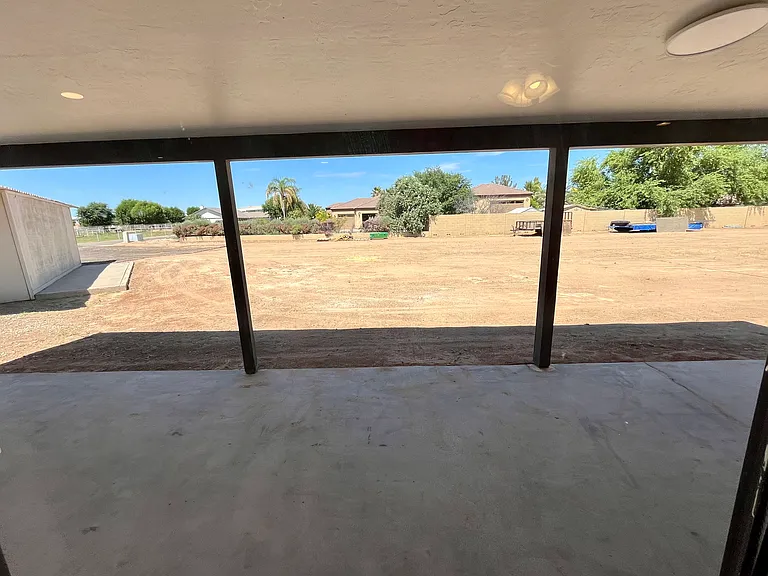 Backyard leading from the rear french doors of main house