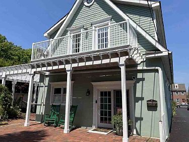 Front of the home showing rocking chairs and balcony.