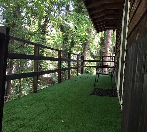 THIS IS THE BIG DECK AT THE APT ENTRANCE.. IT IS 30 FT. LONG AND 6 FT. WIIDE.

THE ROOF OVERHANG SHELTERS THE DOOR.