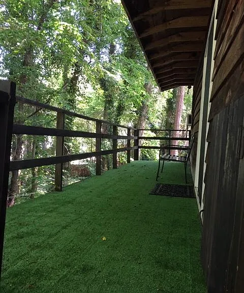 THIS IS THE BIG DECK AT THE APT ENTRANCE.. IT IS 30 FT. LONG AND 6 FT. WIIDE.

THE ROOF OVERHANG SHELTERS THE DOOR.