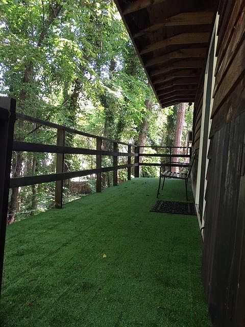 THIS IS THE BIG DECK AT THE APT ENTRANCE.. IT IS 30 FT. LONG AND 6 FT. WIIDE.

THE ROOF OVERHANG SHELTERS THE DOOR.