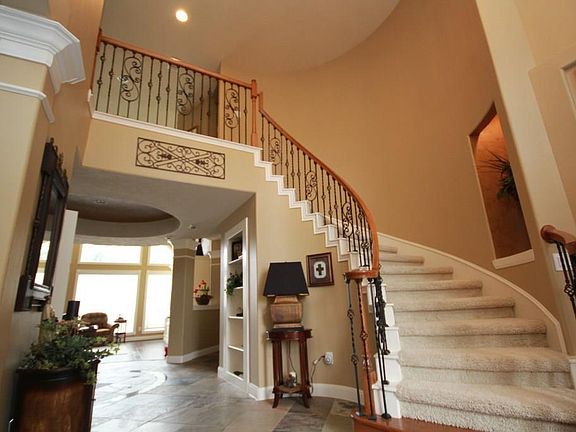 A beautiful curved stairway graces the spacious 2-story front entry with slate floors and leaded-gla