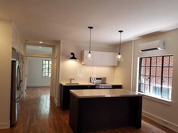 Open living room with kitchen.