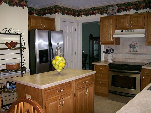 Kitchen with new countertops, new stainless smooth top range and dishwasher