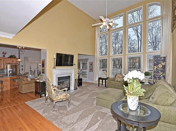 great room has Soaring ceiling plus vaulted with a window wall. See through fireplace compliments both great room and hearth roo