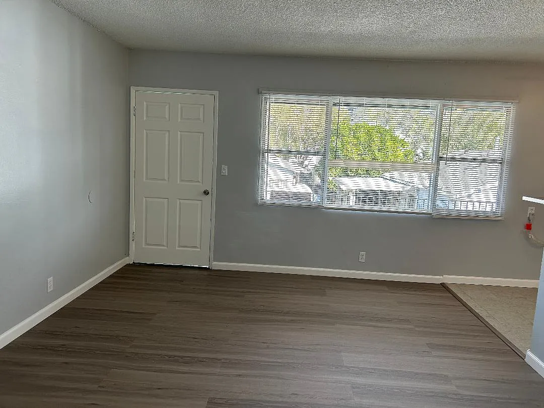 front Living room with brand new mini blinds, brand new linemate floor - 2621 W Ramona Rd #D
