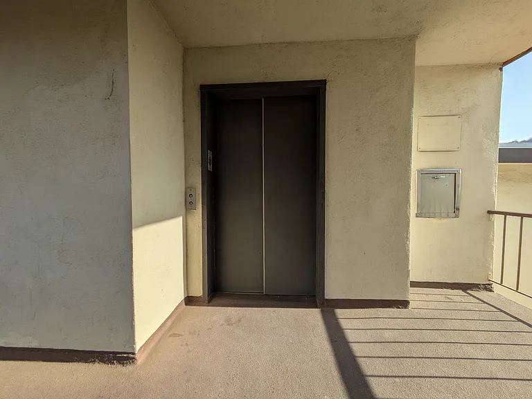 Elevator and trash shoot conveniently located next to front door.