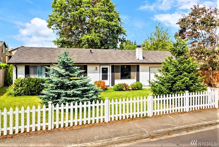 White picket fence welcomes you home with Xmas-like trees guarding the front of desirable rambler in Kent Highlands II. 