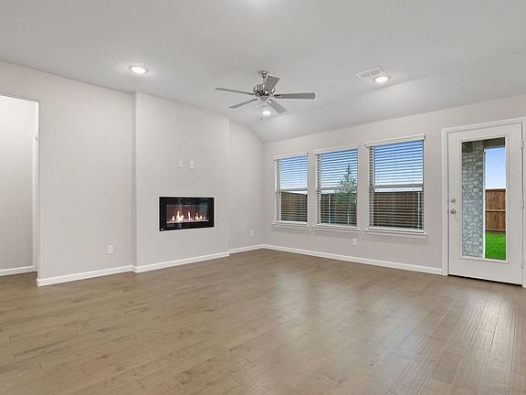 Living room in the Pulitzer home plan by Trophy Signature Homes - REPRESENTATIVE PHOTO