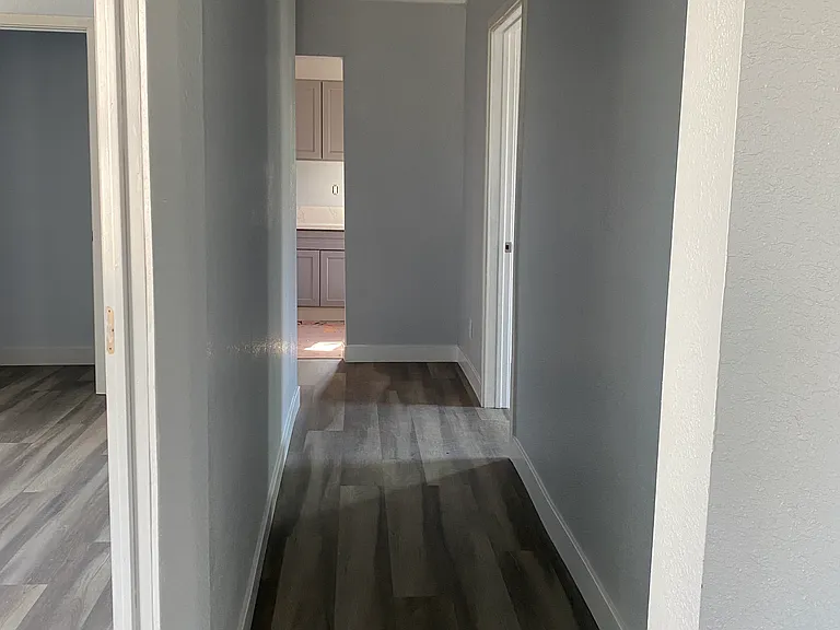 Bedroom 3 (left) and Hallway leading to Kitchen (far back) and Bedroom 2 (right)