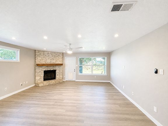 Living room with lots of natural light. Door leads to backyard