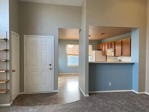 View from living room into eat-in kitchen. Coat/broom closet to the left.