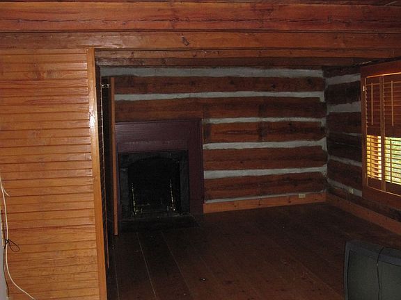 Upstairs bedroom with heart pine log walls
