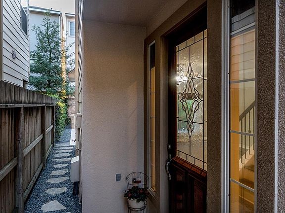 Beautiful etched glass front door entry welcomes you HOME!! Doorbell installed on outside of the locked gate to announce visitors before they reach your front door!!