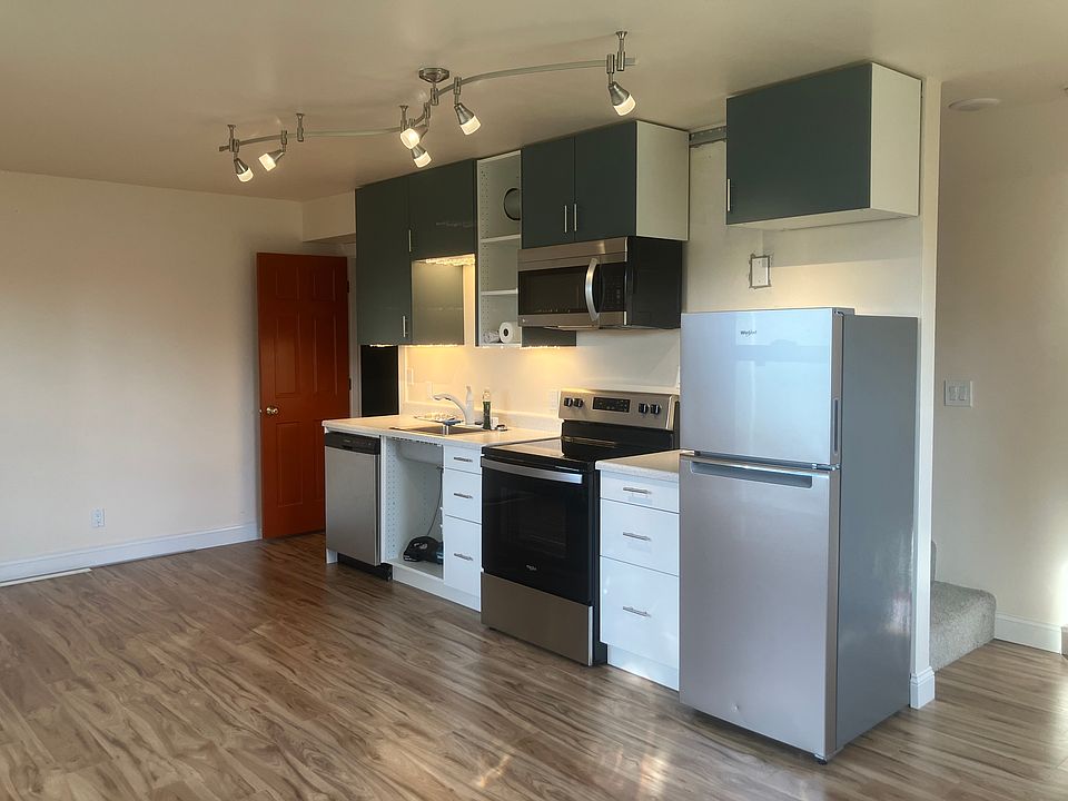 Modern efficiency kitchen with stainless steel appliances.