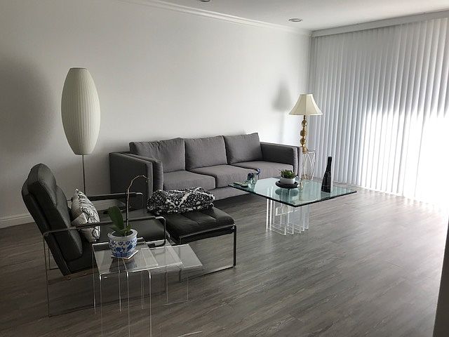Living room. Balcony behind blinds.