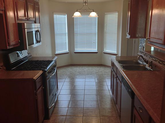 Kitchen with plenty of storage and dining nook overlooking the back yard