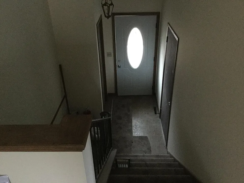 Front door with coat closet & 2 car garage entry