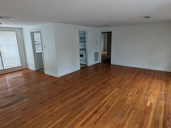 Living room to the right, dining room to the left. The kitchen is straight ahead.
