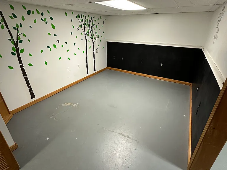 Playroom, mural, and chalkboard half-wall.