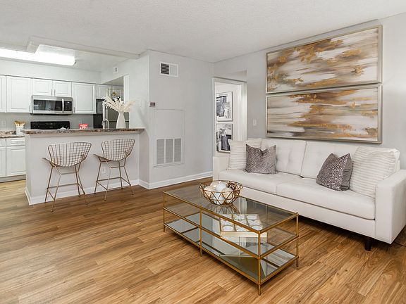 Enjoy effortless entertaining with this open layout, featuring wood-style flooring and soft neutral tones.