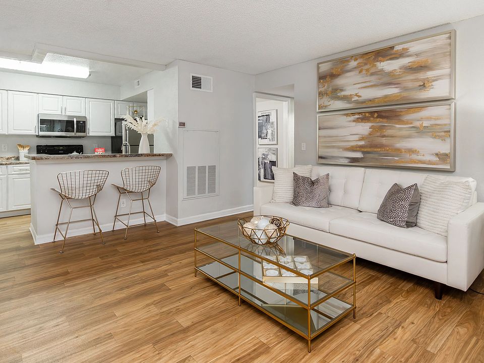 Enjoy effortless entertaining with this open layout, featuring wood-style flooring and soft neutral tones.