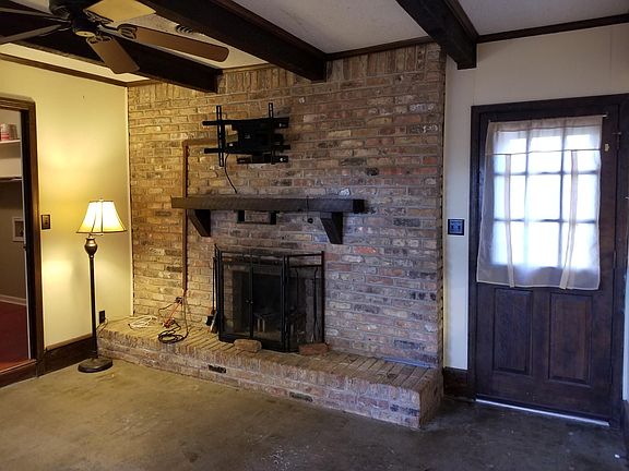 Den with fireplace. Door to backyard.